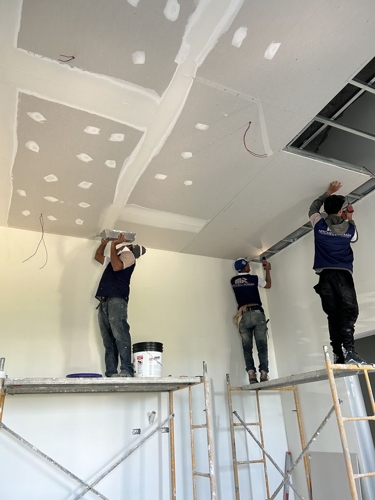 RiverStone crew finishing a commercial ceiling from scaffolding
